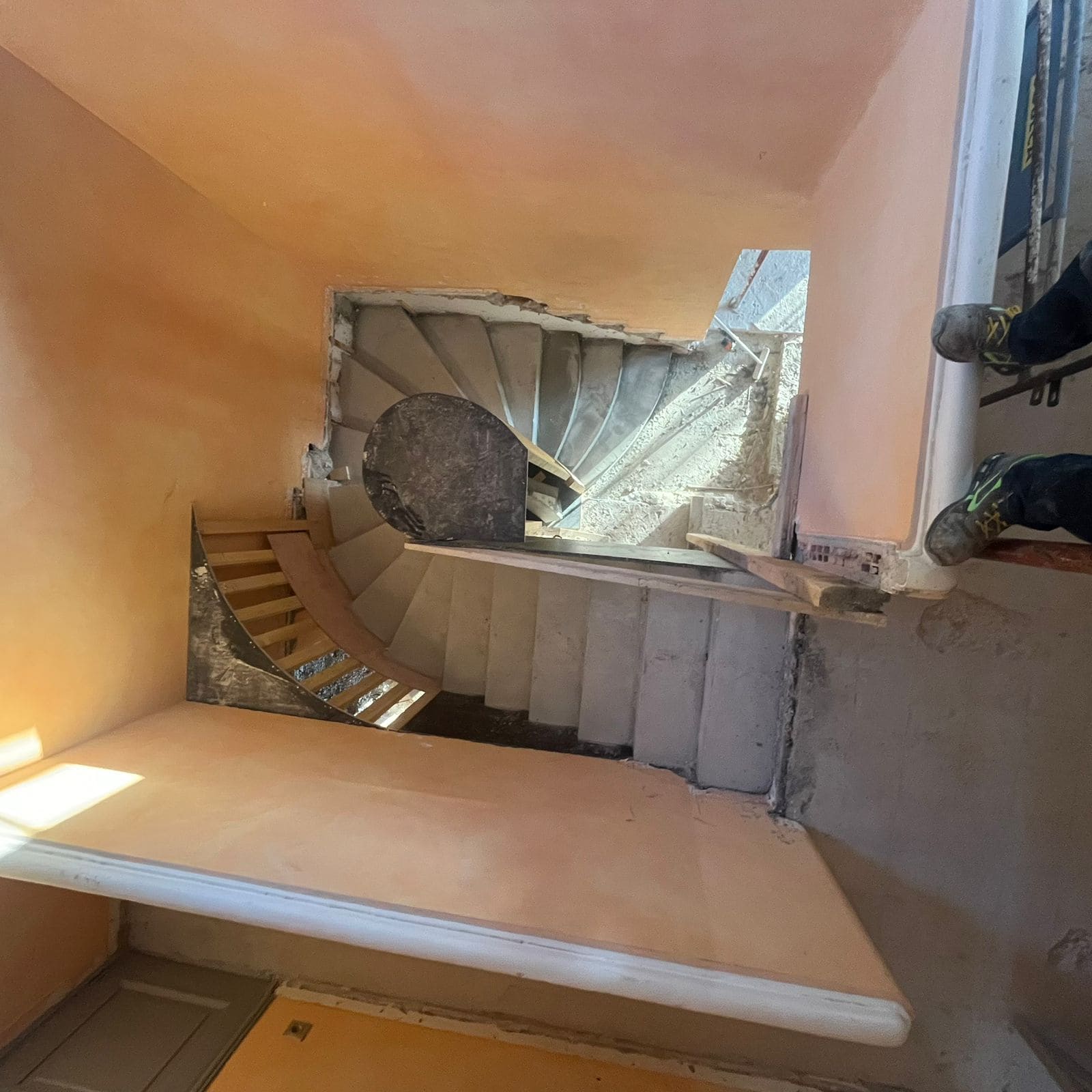 Escalier hélicoïdal en béton réalisé par EMG Rénovation — pièce architecturale d'exception